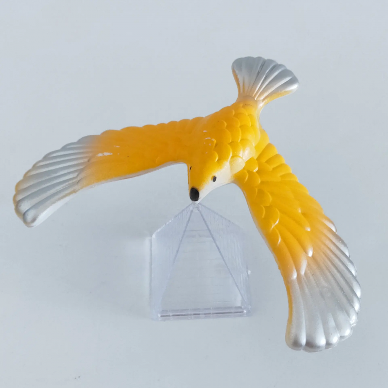 Yellow and silver balancing bird