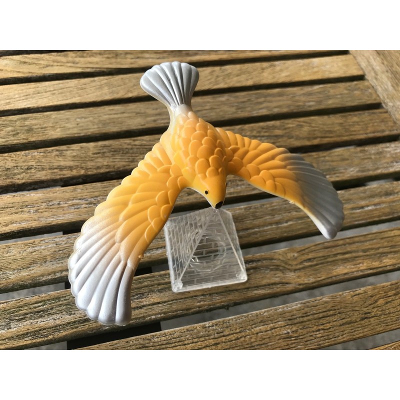 Yellow and silver balancing bird